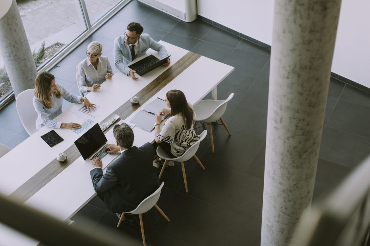 Aerial view at group of business people working together and preparing new project on a meeting in the office.